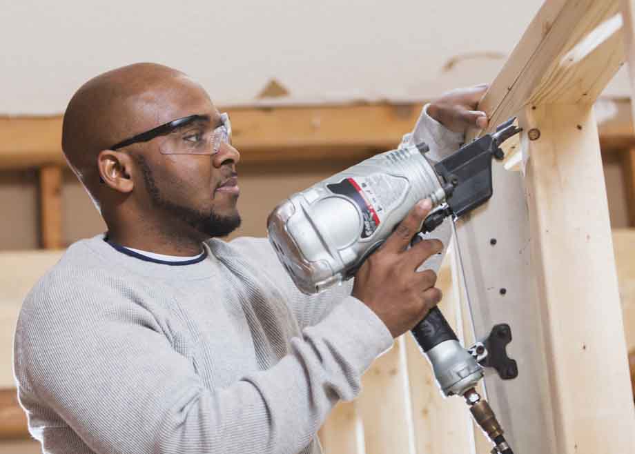 Contractor using nail gun, working on a home remodeling project