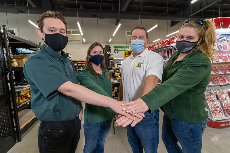 Curtis Lumber employees with hands in center